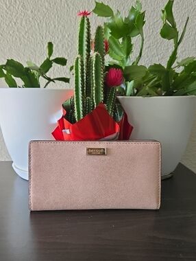kate spade blush pink saffiano continental wallet with gold-toned hardware.